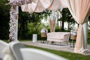 Outdoor modern ceremony pagoda decoration with curtains drapery and pink art deco sofa