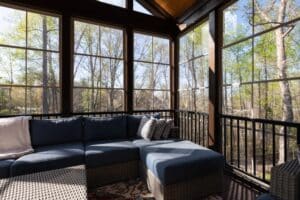 Contemporary screened porch in springtime, full of blooms trees in the background. New home addition concept.